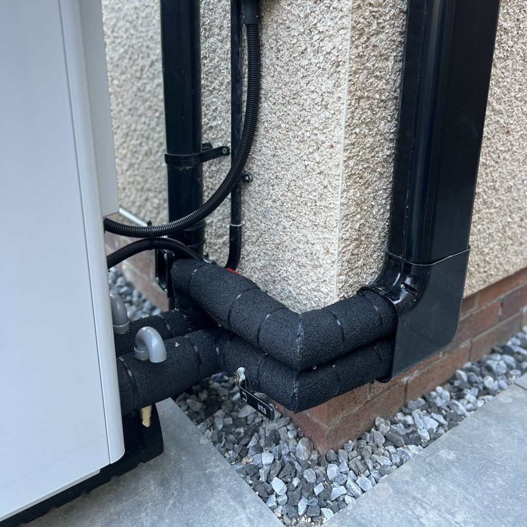Insulated pipework and cable routing for an air source heat pump installation in Scotland by Aventus Eco